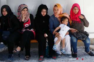 Refugees attend a meeting with Pope Francis at the Moria refugee camp on the island of Lesbos, Greece April 16, 2016. U.S. Catholic and Lutheran leaders lament that the immigration cap of 50,000 refugees set by President Donald Trump had been reached.