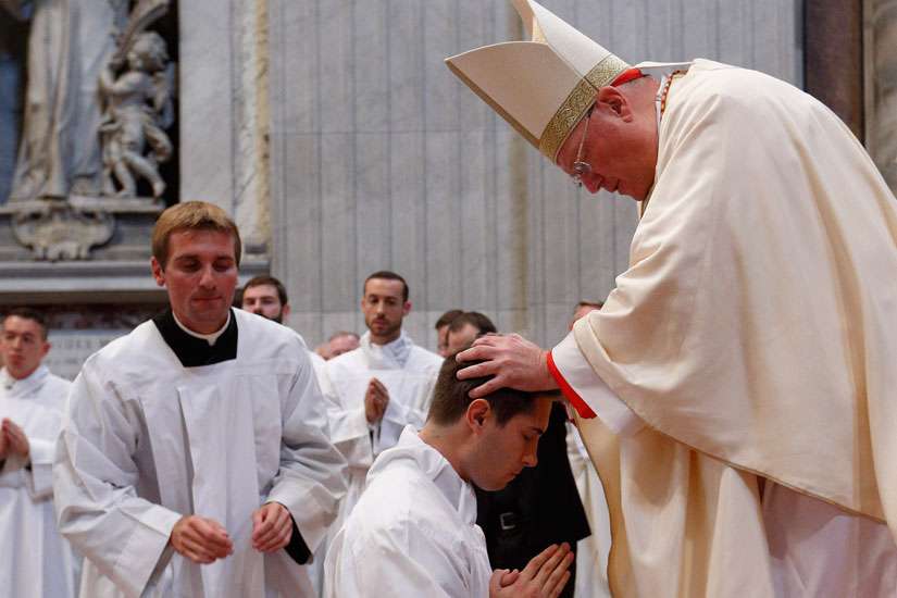 Cardinal Timothy M. Dolan of New York ordains seminarian Scott Valentyn of the Diocese of Green Bay, Wis., as a transitional deacon during the ordination of 40 new deacons from the Pontifical North American College in St. Peter&#039;s Basilica at the Vatican Oct. 1.