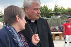 Daniela Pompei confers with Cardinal Konrad Krajewski, the papal almoner, during a May 2019 visit to the Moria refugee camp on the Greek island of Lesbos. The cardinal has tested positive for COVID-19 and is hospitalized.