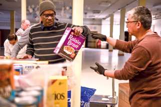Food bank volunteers unload donations. At the Mississauga Food Bank, some clients have asked about assisted suicide.