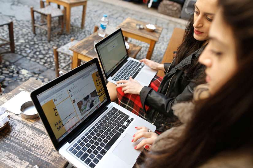 Turkish women try to connect to Twitter at a cafe in Istanbul, Turkey, March 21. In the United States, the Federal Communications Commission is trying to decide whether to formulate a new policy for governing access to the Internet.