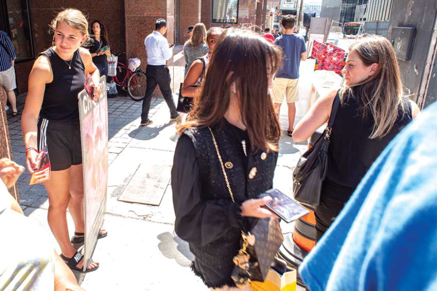 Members of the pro-life Centre for Bioethical Reform hand out flyers in midtown Toronto.