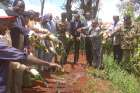 Community leaders, politicians and administration officers pour contents of an illicit brew during a crackdown in July 2015.