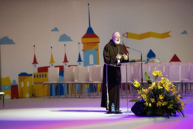 Boston Cardinal Sean P. O&#039;Malley speaking in front of World Youth Day graphics, July 27 in Krakow, Poland. The graphic designer was passed away of cancer just before the start of Krakow 2016.