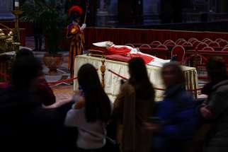 People pay their respects at the body of Pope Benedict XVI in St. Peter&#039;s Basilica at the Vatican Jan. 2, 2023.
