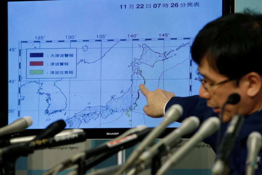 Koji Nakamura, earthquake and volcano observations division director of the Japan Meteorological Agency, points at a map showing earthquake information during a news conference in Tokyo Nov. 22.