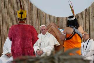  Pope Francis listens to members of an indigenous group from the Amazon region during a Jan. 19 meeting at Madre de Dios stadium in Puerto Maldonado, Peru.