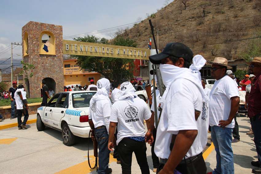 A group of armed civilians is seen May 28 in the southern Mexican state of Guerrero. Bishops in Guerrero have suffered threats from organized criminal groups as they serve a region rife with drug cartel activities and parishes located in impoverished indigenous communities where people eke out existences by cultivating opium poppies.