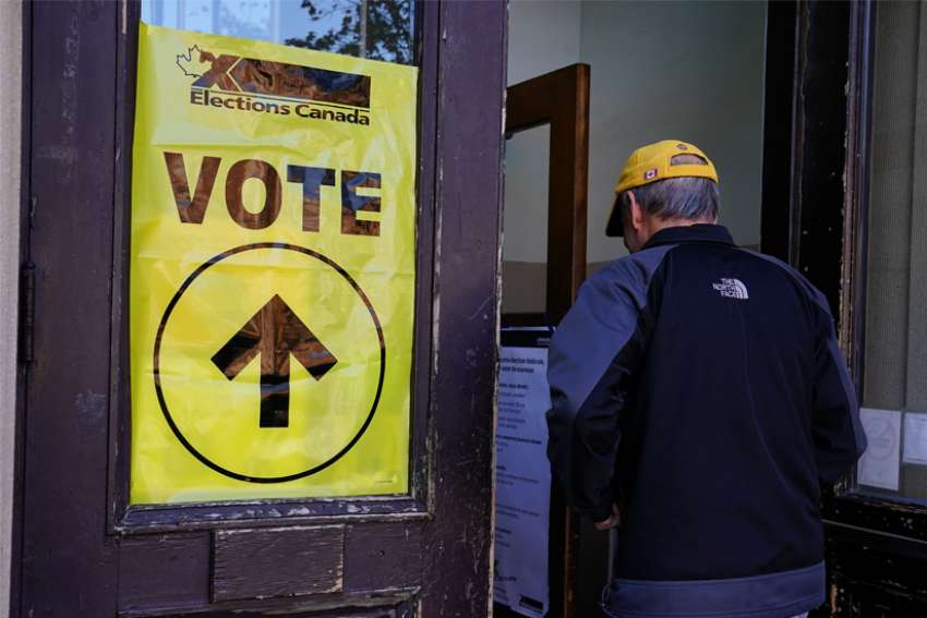 A man is pictured entering a polling place in Montreal Oct. 21, 2019. Although three in five Canadians felt having a federal election this fall was not important to them, the country is headed to its second general election in less than two years.