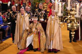King Charles III sits on the throne after being crowned with St. Edward&#039;s Crown by Archbishop Justin Welby of Canterbury during his coronation ceremony at Westminster Abbey in London.