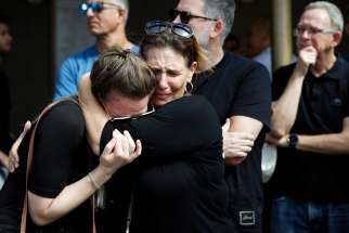 Family and friends mourn Danielle, 25, and Noam, 26, an Israeli couple who were killed in a deadly attack by Hamas gunmen from Gaza as they attended a festival, as they are buried next to each other during their funeral in Kiryat Tivon, Israel, Oct. 12, 2023.