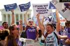 Pro-abortion protesters celebrate when the U.S. Supreme Court struck down two provisions of a 2013 Texas law regulating abortion in the state. 