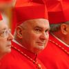 U.S. Cardinal John P. Foley sits among other cardinals after receiving his red biretta from Pope Benedict XVI during a consistory in St. Peter&#039;s Basilica at the Vatican in this Nov. 24, 2007, file photo. Cardinal Foley, a dean of the Catholic press in t he United States, died Dec. 11 in Darby, Pa., after a battle with leukemia. He was 76.