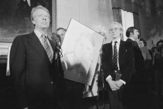 Andy Warhol presents President Jimmy Carter wth a portrait at the White House in June 1977. 