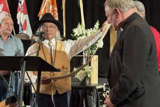 Former Kamloops Chief Manny Jules presents Archbishop Michael Miller with a stole marked with symbols Tk’emlúps historical events. On Easter Sunday, Miller and Kamloops Bishop Joseph Nguyen signed a Sacred Covenant with the Kamloops First Nation to forge a new relationship between the Church and Indigenous peoples.