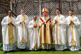 Following the May 10 ordination at St. Michael&#039;s Cathedral Fr. Neiman D&#039;Souza, Fr. Scott Birchall, Fr. Michael Simeos, Cardinal Thomas Collins,  Fr. Marijan Šiško and Fr. Omar Hernandez (left to right), gather in the rector&#039;s backyard. 