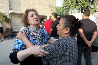 Women react outside St. Porphyrios Greek Orthodox Church in Gaza Oct. 20, 2023, after an explosion went off the night before. Several hundred people had been sheltering at the church complex, many of them sleeping, at the time of the explosion.