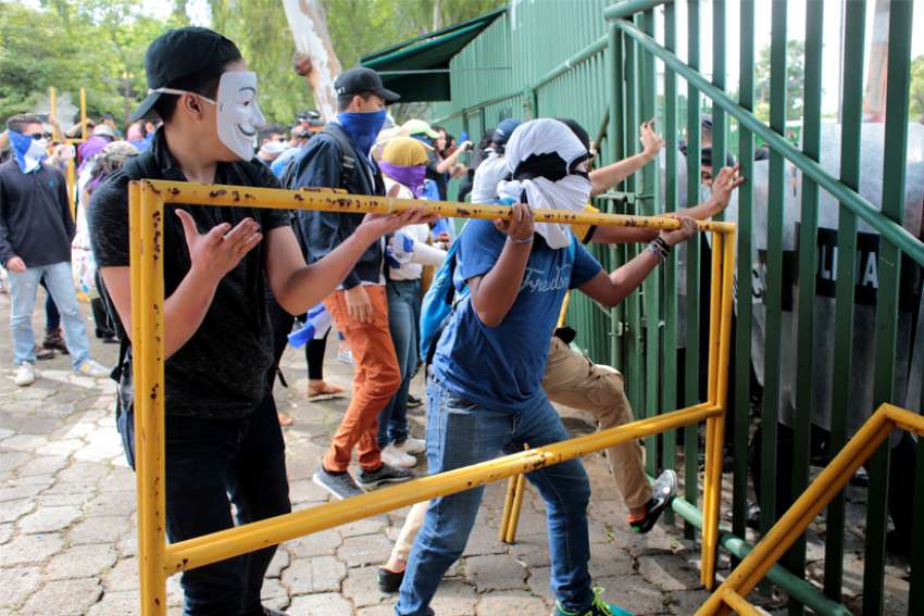 Protesters block the entrance of the Central American University during a Nov. 19, 2019, protest against Nicaraguan President Daniel Ortega&#039;s government in Managua, the capital. Supporters of Ortega Nov. 21 tried to enter St. John the Baptist Parish in Masaya, just south of Managua, forcing churchgoers to barricade the doors with pews.
