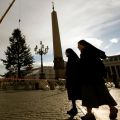 Nuns walk by the Vatican&#039;s Christmas tree as it&#039;s positioned in St. Peter&#039;s Square at the Vatican Dec. 6. The tree is a 78-foot silver fir from the southern Italian region of Molise.