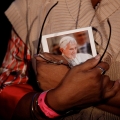 A woman holds a photograph of Pope Benedict XVI during a prayer vigil at Hyde Park in London last September. His visit prompted a wave of fresh allegations of historical clerical sexual abuse.