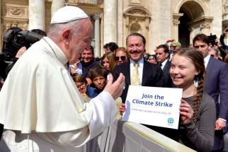 Pope Francis greets Swedish climate activist Greta Thunberg during his general audience in St. Peter’s Square at the Vatican in April.