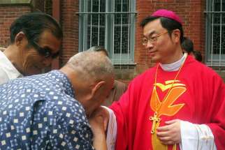 A well-wisher is pictured in a file photo kissing the ring of Bishop Thaddeus Ma Daqin following his episcopal ordination at St. Ignatius Cathedral in Shanghai.