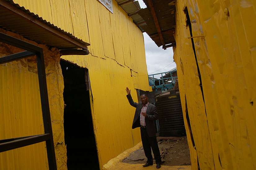 Pastor Steve Shirima, the leader of Jesus Is the Key of Life, a Pentecostal church, explains how his church was painted yellow. The church is deep within the shacks of a slum. 