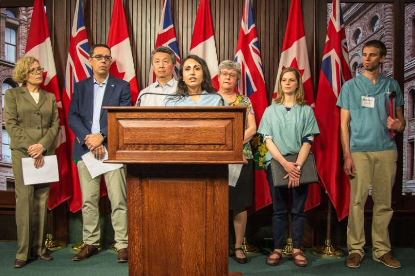 Health care professionals descended on Queen’s Park May 18 in support of a Progressive Conservative private member’s bill regarding conscience rights. From left to right: Dr. Jane Dobson, pharmacist James Brown, Dr. Doug Mark, Dr. Kulvinder Gill, nurse Helen McGee, medical student Lauren Mai and Dr. Stephen Vanderklippe.