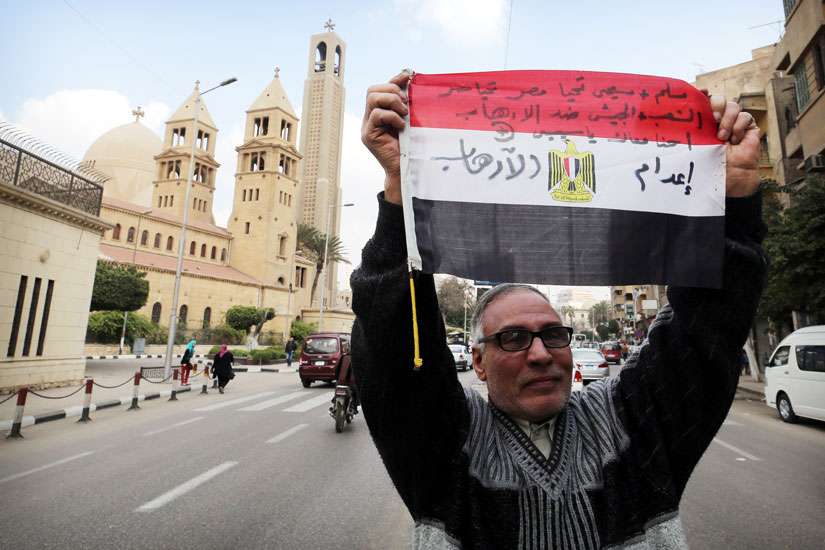 A man in Cairo Feb. 16 denounces the killing of Egyptian Christians in Libya. U.S. Secretary of State John Kerry said atrocities carried out by the Islamic State group against Yezidis, Christians and other minorities were genocide, the first U.S. declaration of genocide since Sudanese actions in Darfur in 2004.