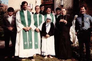 Msgr. Ambrose Sheehy stands behind Mother Teresa at the opening of the novitiate of the Missionaries of Charity Fathers in New York City in 1984.