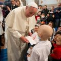 Pope Francis receives a letter from a child during a visit to the Bambino Gesu children&#039;s hospital in Rome Dec. 21.