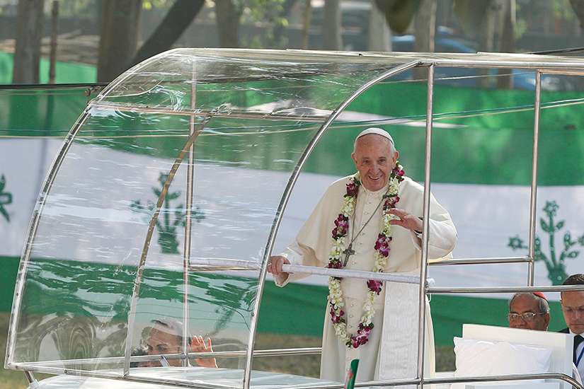 Pope Francis wears a garland as he greets the crowd before celebrating Mass and the ordination of priests in Suhrawardy Udyan park in Dhaka, Bangladesh, Dec. 1. 