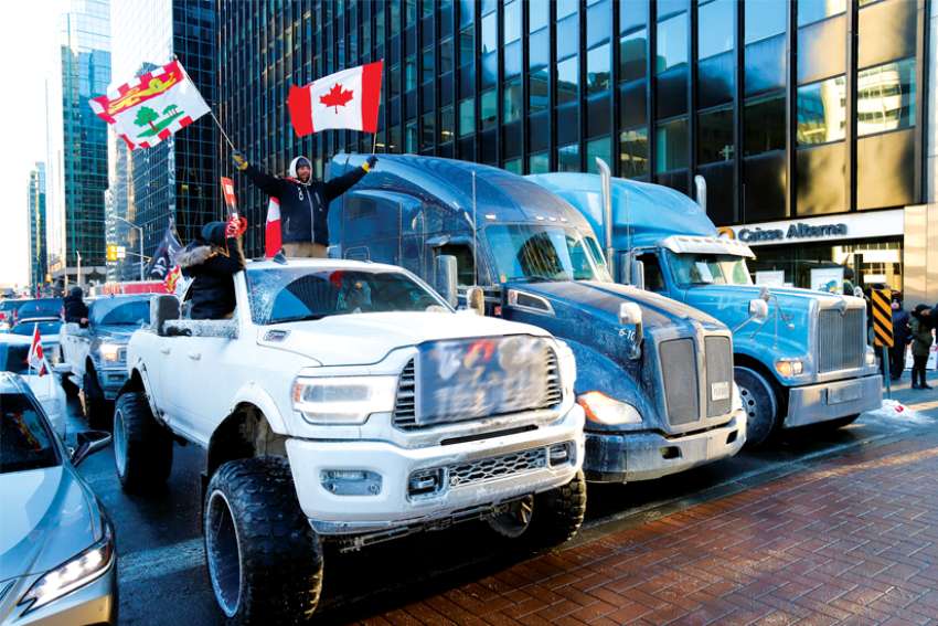 Trucks block a downtown Ottawa road as truckers and supporters take part in a convoy to protest the COVID-19 vaccine mandates for cross-border truck drivers.