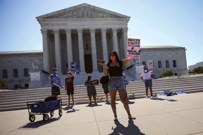 Pro-life activists gather outside the U.S. Supreme Court in Washington June 29.