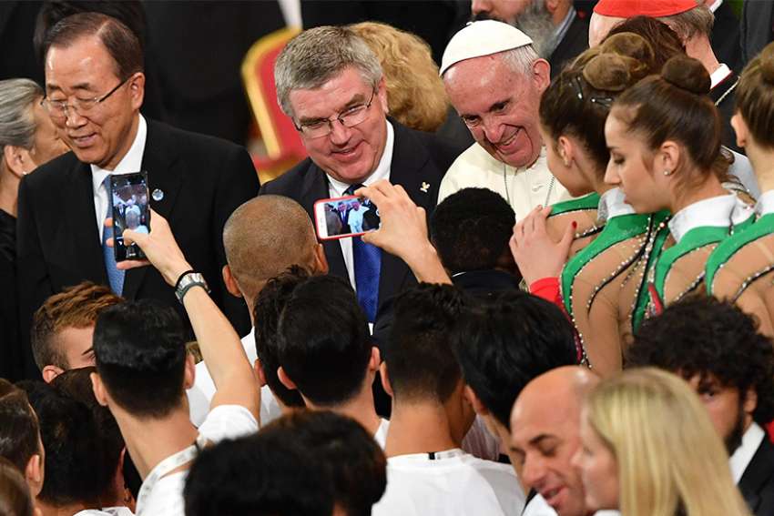 Pope Francis is seen with U.N. Secretary-General Ban Ki-moon, left, and Thomas Bach, president of the International Olympic Committee, during the opening ceremony of a world conference on faith and sport Oct. 5 in the Vatican&#039;s Paul VI audience hall in 2016.