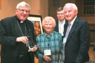Cardinal Thomas Collins presents Paul and Margaret O’Connor the Bishop Michael Power Award at the ShareLife Mass of Thanksgiving in 2014.