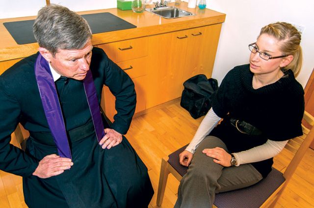 Michelle Duklas (right) visits with Fr. Daniel Utrecht at the Archdiocese of Toronto’s Pastoral Centre during the April 9 Day of Confessions.