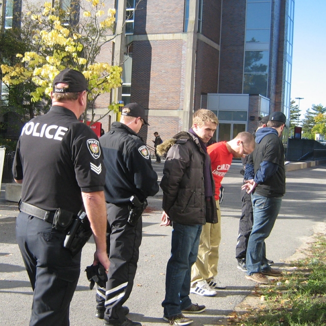 Carleton Lifeline members, from left, Craig Stewart, James Shaw and Nicholas McLeod, are arrested last October by Ottawa Police for trespassing on the Ottawa university campus after setting up a pro-life display.