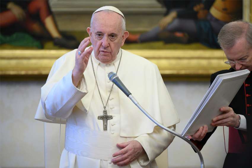 Pope Francis delivers his blessing as he leads his general audience in the library of the Apostolic Palace at the Vatican June 17, 2020. During the audience, the pope said that true believers do not condemn people for their sins or shortcomings but intercede on their behalf with God through prayer.