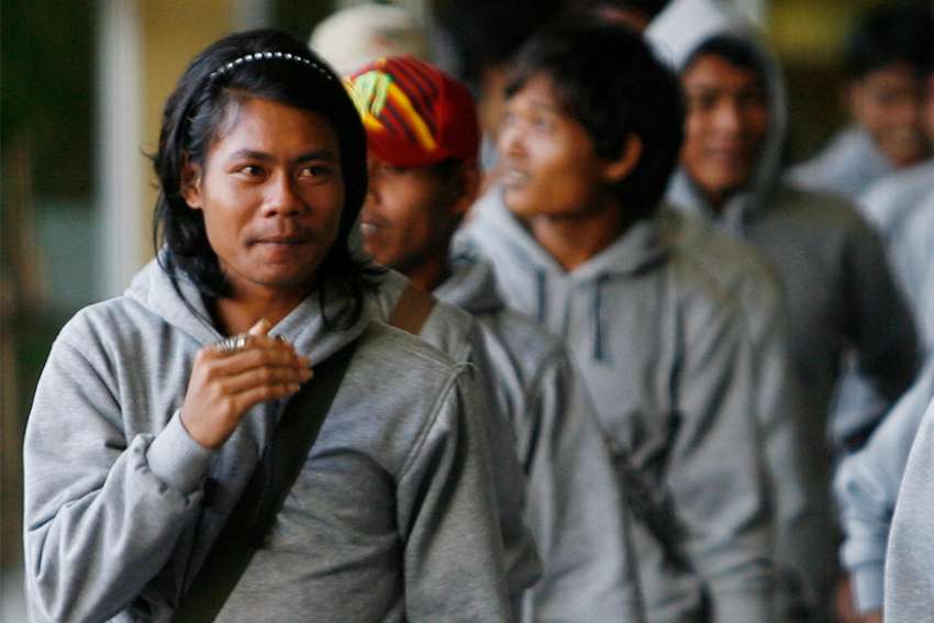 Trafficked Cambodian fishermen arrive in 2013 at Phnom Penh International Airport in Cambodia. The 30 trafficked Cambodian fishermen returned home from Indonesia with help from Indonesian authorities and International Organization for Migration.