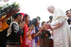 Pope Francis greets children as he arrives at Yangon International Airport in Yangon, Myanmar, Nov. 27. The pope is making a six-day visit to Myanmar and Bangladesh. 
