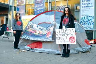 Nina Moshy, left, and Rosemary Yachouh stand in front of the Ryerson Student Centre to spread awareness about the plight of Syrian refugees.
