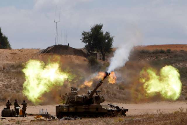 An Israeli mobile artillery unit fires toward the Gaza Strip July 18. Pope Francis telephoned Israeli President Shimon Peres and Palestinian President Mahmoud Abbas July 18, urging all sides to end hostilities and build peace.