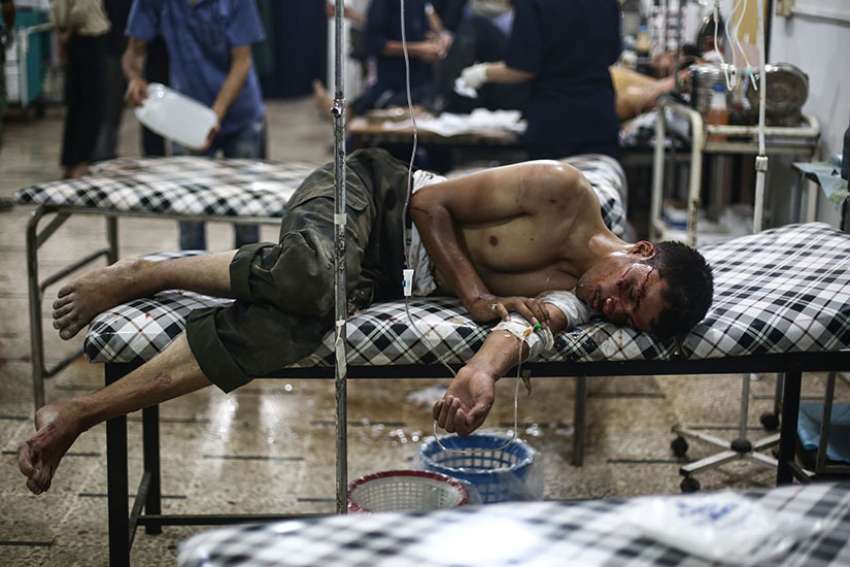 A young Syrian man receives medical treatment July 21 at a field hospital in the region of Douma in Damascus, Syria.