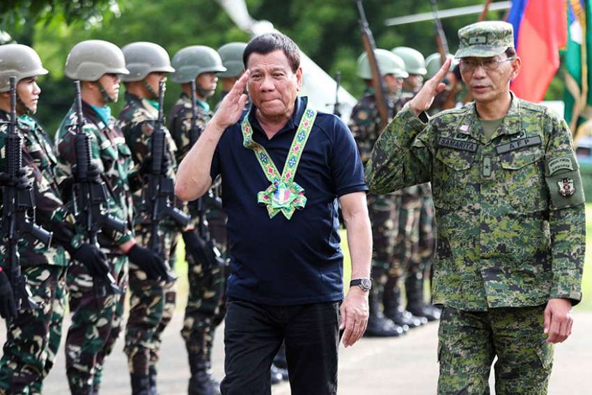 Philippine President Rodrigo Duterte is seen with the military in Carmen, Philippines, June 6. The Association of Major Religious Superiors in the Philippines called for an end to martial law in Mindanao, saying it was not the proper response to terrorist attacks in one city on a vast island.