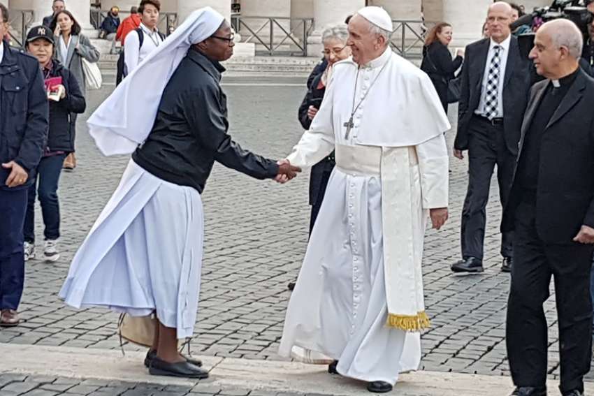 Pope Francis greets a woman religious in St. Peter&#039;s Square at the Vatican Nov. 16, 2018.