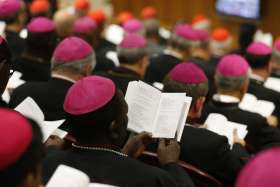 Bishops pray at the start of a session of the Synod of Bishops at the Vatican Oct. 9, 2018.