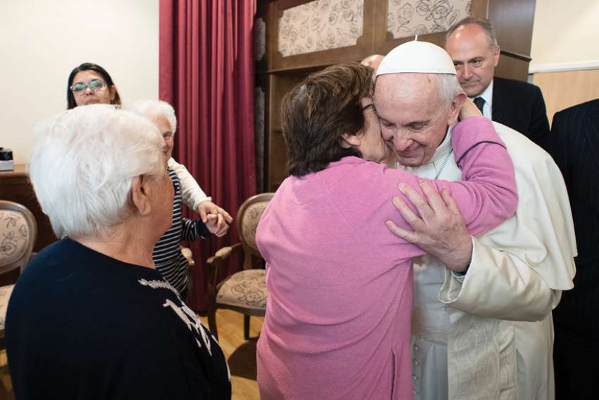 In this 2019 photo, Pope Francis greets residents of Rome’s Emanuele Village, home to people with Alzheimer’s, the most common form of dementia.