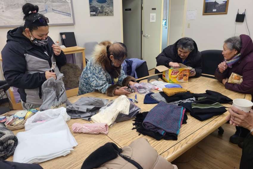Elders sort through clothing donations to their Arctic community through the Vincentians’ North of 60 program.