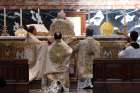 Cardinal Walter Brandmuller elevates the Eucharist during a Tridentine-rite Mass at the Altar of the Chair in St. Peter’s Basilica at the Vatican in 2001, the  first time in several decades that the rite was celebrated at the altar.